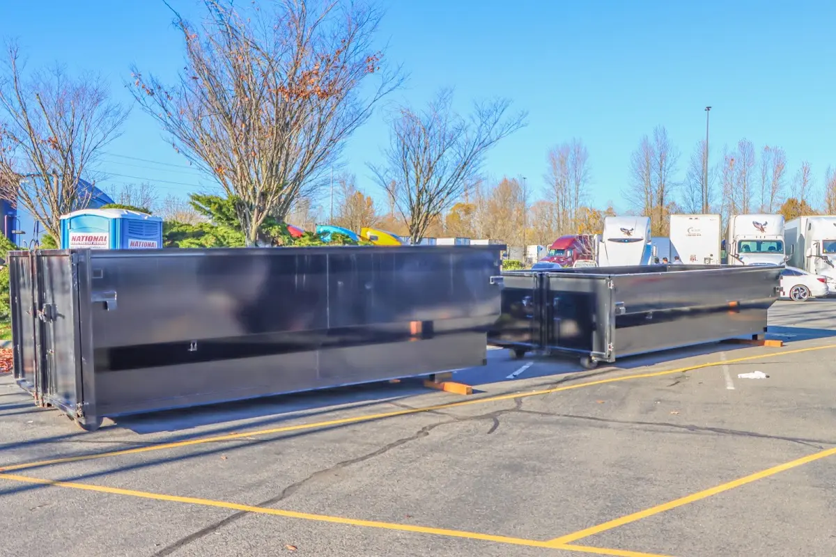 Professional dumpster rental service with roll-off container on residential driveway in Beachwood